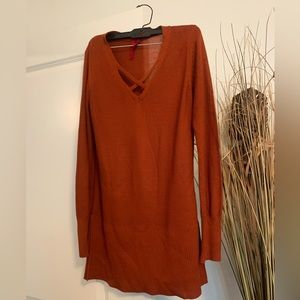 Rust color sweater with slit on each side of sweater